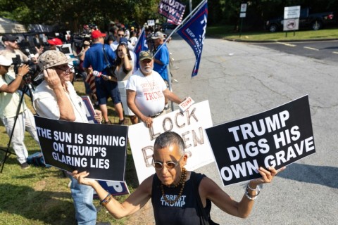 Protester outside the Fulton County Jail, where former president Donald Trump is to be booked on racketeering charges