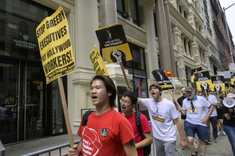 Screen Actors Guild members walk a picket line outside of Warner Bros. Discovery on August 10, 2023, in New York City