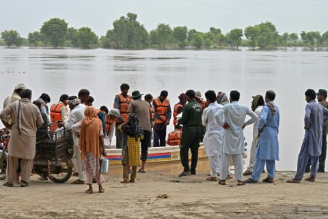 Rescue personnel evacuate people from a flooded village in Pakistan's eastern Punjab province