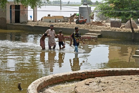 Villagers wade through floodwaters in Okara district Pakistan's eastern Punjab province