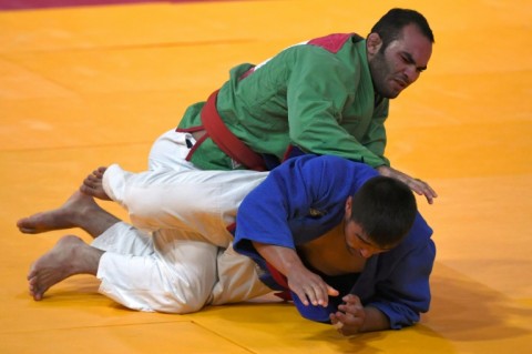 Iran's Elyas Ali Akbari (left) fights Uzbekistan's Sarvar Shomurodov in the men's -81kg category kurash at the 2018 Asian Games in Jakarta