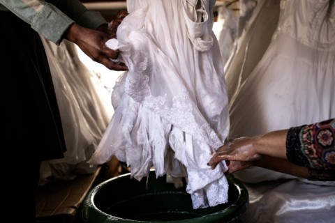The wedding gowns are cleaned, dried and pressed before being rented out again
