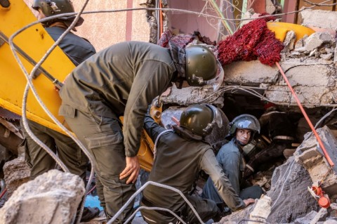 Rescue workers search for survivors in a collapsed house in Moulay Brahim