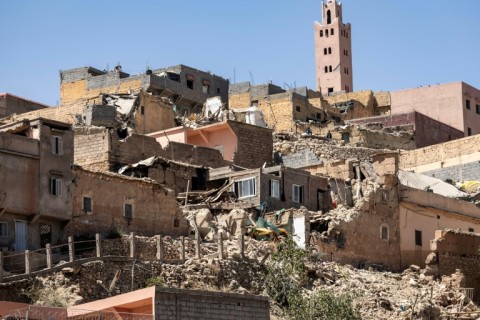 The minaret of a mosque stands behind destroyed houses in Moulay Brahim, Al-Haouz province