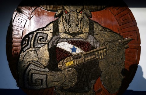 The Soure military police unit's headquarters is adorned with a plaque made of bullet casings depicting a muscular buffalo holding a shotgun