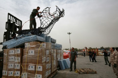 Soldiers in Amman prepare to load a Jordanian military plane loaded with food parcels, tents, blankets and mattresses
