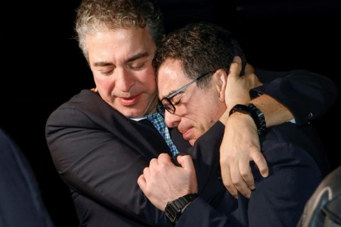 A family member hugs freed US citizen Siamak Namazi (R) upon his arrival at an airbase near Washington on September 19, 2023