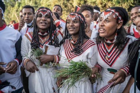 Women dressed in traditional clothing gather for the thanksgiving festival
