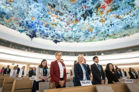 Delegates stand for a minute of silence following war between Israeli forces and the Palestinian militant group Hamas and a series of earthquakes in western Afghanistan, during a session of the UN Human Rights Council in Geneva