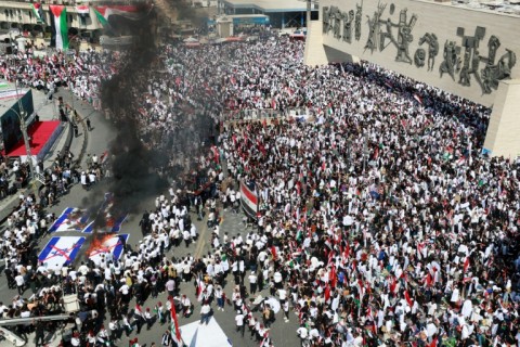 Protesters burn Israeli flags during a demonstration at Tahrir Square in Baghdad