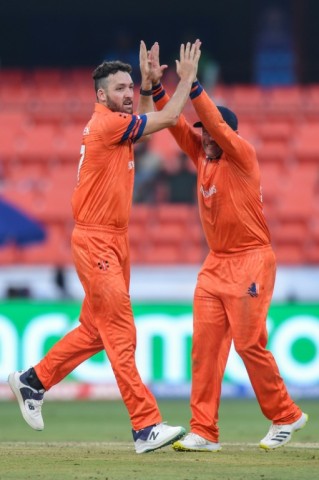 That's out: Netherlands' Paul van Meekeren (left) celebrates after taking the wicket of New Zealand's Daryl Mitchell in Hyderabad