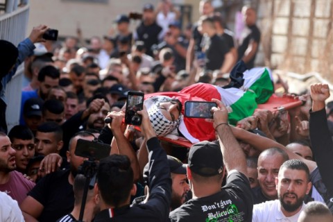 Mourners carry the body of a Palestinian man killed during clashes with the Israeli army in the al-Jalazoun refugee camp, at their funeral in the West Bank city of Ramallah on October 23, 2023