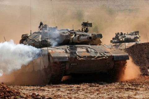 A picture from October 24, 2023 shows Israeli Merkava tanks take part in a military drill near the border with Lebanon in the upper Galilee region of northern Israel 