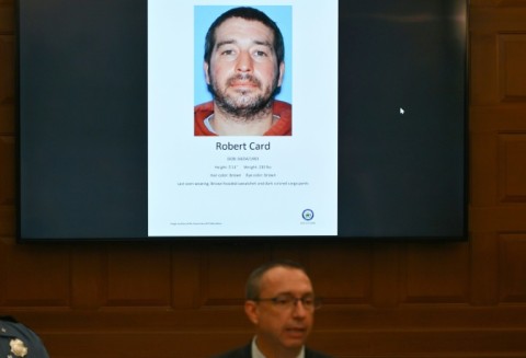 Maine Department of Public Safety Commissioner Mike Sauschuck speaks during a press conference at Lewiston City Hall in Lewiston,  Maine, under a picture of suspect Robert Card on October 27, 2023