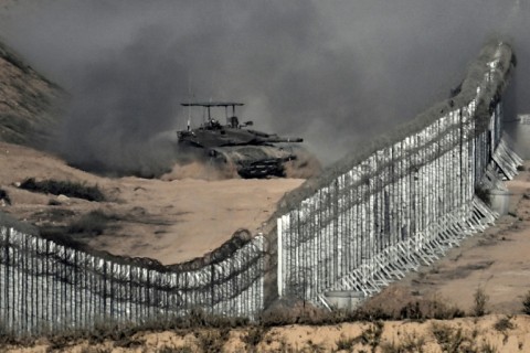 In this picture taken from the Israeli side of the border fence, an Israeli tank rolls inside the Gaza Strip on November 5, 2023 amid ongoing battles between Israel and the Palestinian Hamas movement