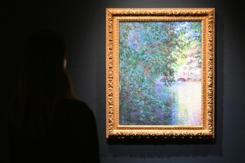 A person looks at a painting by Claude Monet 'Le Moulin de Limetz (The Mill at Limetz)' during Sotheby’s fall preview in New York 