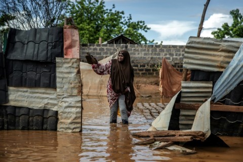 Fatuma Hassan Gumo tries to retrieve some of her belongings from her flooded home 