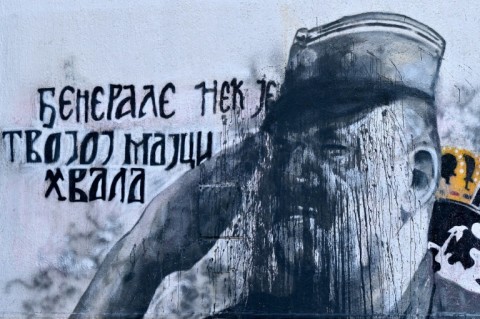 A defaced mural of war criminal and former Bosnian Serb military chief Ratko Mladic