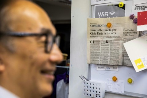 Alan Leong looks at newspaper clippings as he prepares to vacate the offices of the Civic Party, once the second-largest opposition presence in Hong Kong's legislature