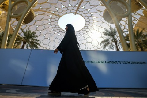 A woman walks through the COP28 site in Dubai