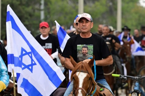 Friends and relatives of Israeli Idan Shtivi, held captive by Hamas, take part in a cavalcade calling for the release of all hostages in Gaza