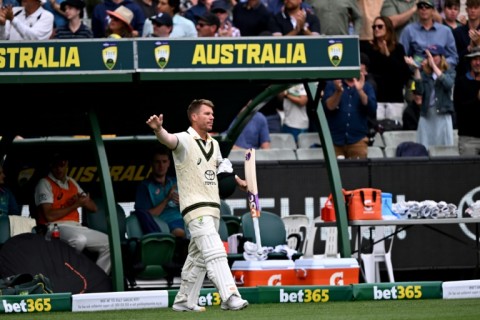 Australian batsman David Warner waves to fans at the Melbourne Cricket Ground