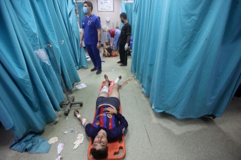 A wounded Palestinian youth lies in a hospital after Israeli bombardment of Khan Yunis