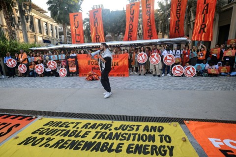 Standing ovation as nations adopt climate deal on fossil fuels