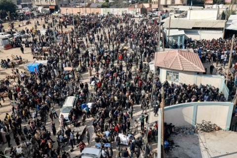 Gazans gather to receive flour rations from the UN relief agency in Rafah 