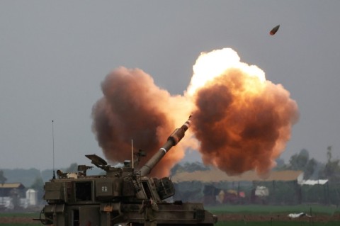 An Israeli tank shells Gaza from southern Israel