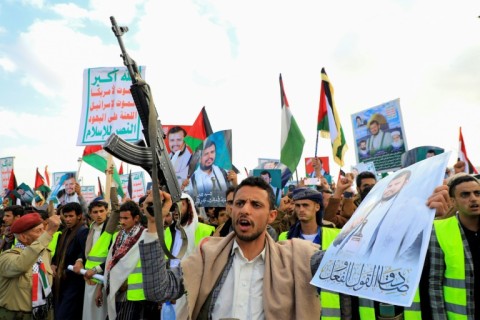 Yemenis brandish guns during a march in solidarity with the Palestinians of Gaza, in the Huthi-controlled capital Sanaa on December 15, 2023