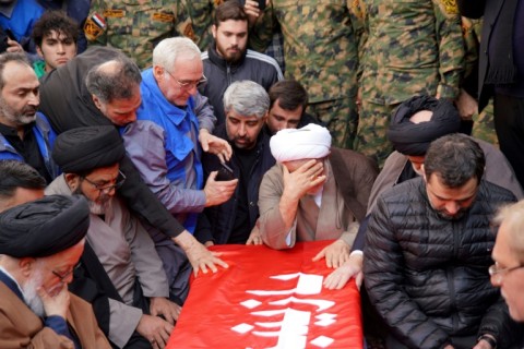Mourners pray over the coffin of Iranian military commander Razi Moussavi who was killed in an Israeli strike in Syria, at his funeral procession in Iraq's holy city of Najaf, on December 27, 2023