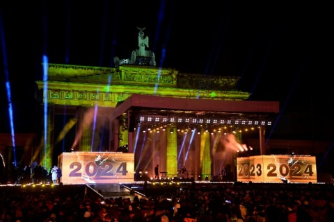 The year '2024' is displayed on a digital board as performers get ready for the next act during the New Year party in front of the landmark Brandenburg Gate in Berlin, Germany on New Year's Eve, December 31, 2023