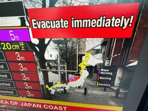 A video image taken in Hong Kong shows a warning message from a live feed on NHK World asking people to evacuate after a series of major earthquakes in central Japan prompted tsunami warnings