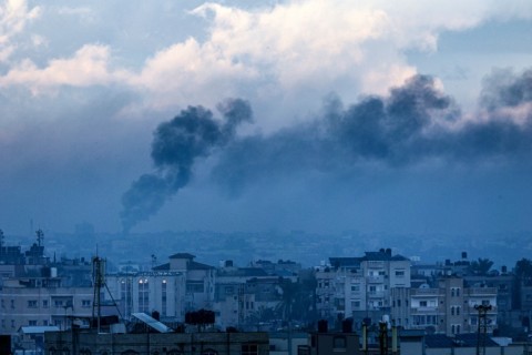 A picture taken from Rafah shows smoke billowing over Khan Yunis during an Israeli bombardment on Tuesday