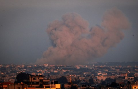 Seen from Rafah, smoke billows over Khan Yunis city, the southern Gaza Strip, during Israeli bombardment