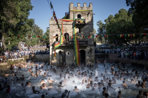 Dozens of children and young men jumped into the cold water of the Fasilides baths, splashing the crowds on the sides