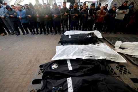 Palestinians pray before the bodies of relatives killed in the latest bombardment of Khan Yunis and Rafah