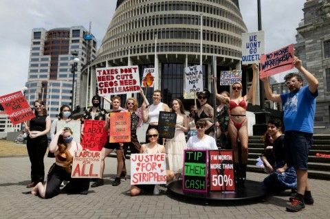 Activists and organisers pose for a photo during a sex industry workers rights protest at Parliament Grounds in Wellington on February 1, 2024.