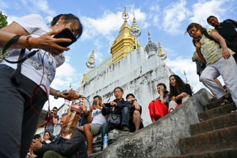 Tourists inject much-needed money into Laos' shaky economy but present locals with a dilemma, as foreign tour groups dominate and change cultural activities 