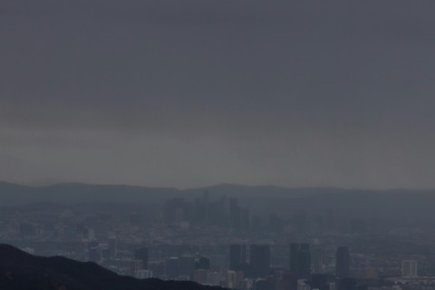 Heavy rainclouds hover over buildings in downtown Los Angeles on February 4, 2024