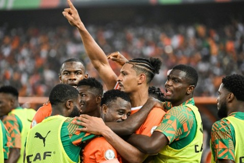 Sebastien Haller (C) takes the acclaim of his Ivory Coast teammates after scoring the winner against DR Congo in the semi-final