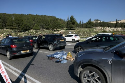 A body lies on the road near Maale Adumim Jewish settlement, east of Jerusalem, after a shooting attack that killed one person 