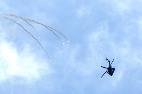 An Israeli army helicopter firing flares above the Gaza Strip on February 20, 2024