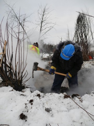 This handout picture provided by Alberta Wildfire shows firefighters digging to unearth zombie fires in Fox Lake that burn beneath the snow-covered ground