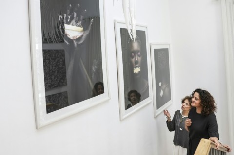 Shah (right) shows a client a display of a previous collection at her Nairobi studio