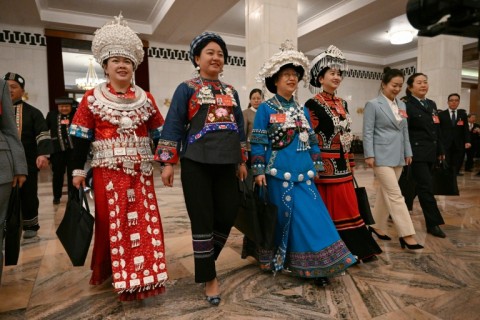 Ethnic minority delegates arrive for the opening session of the National People's Congress (NPC) at the Great Hall of the People in Beijing on March 5, 2024.