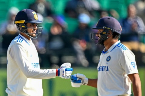 India's captain Rohit Sharma (R) fist bumps Shubman Gill during the second day of the fifth Test against England 
