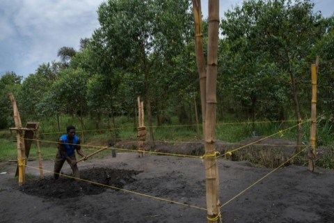 The makeshift wrestling ring is fashioned out of bamboo poles and thin yellow rope 