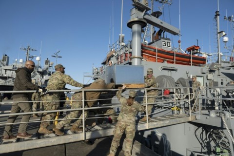 US Army soldiers load an AC unit aboard the USAV Monterey on March 12, 2024 ahead of the vessel's departure for an operation to construct a temporary port on Gaza's coast